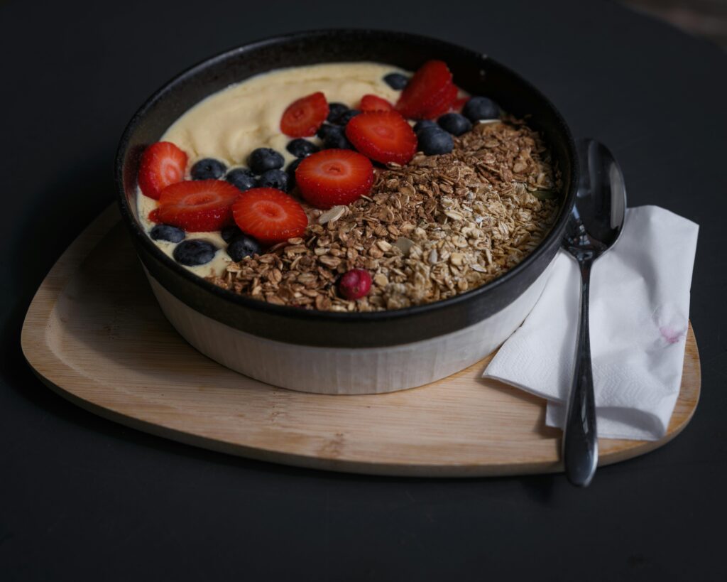 Bowl of granola with strawberries, blueberries and yoghurt