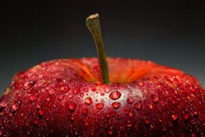 Red apple with water droplets close-up