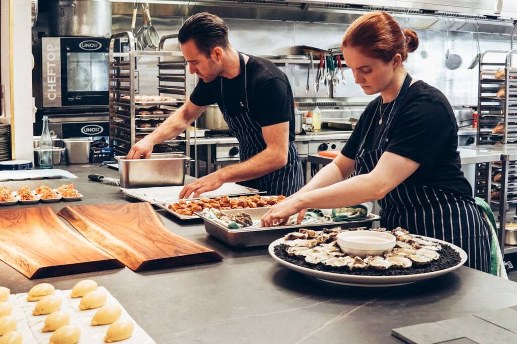 Chefs preparing dishes in a professional kitchen